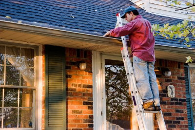 man fixing gutters