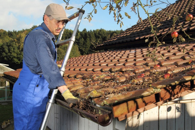 man cleaning gutters